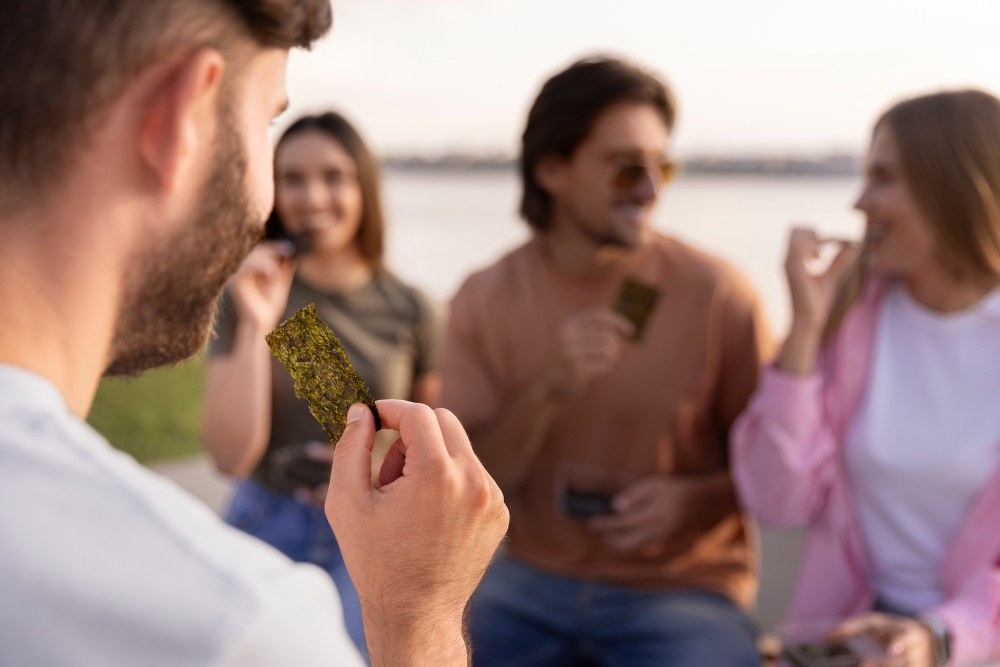 Group of friends enjoying snacks outdoors, representing the social and community aspect that aligns with smoking club requirements for member engagement and non-commercial activity.

