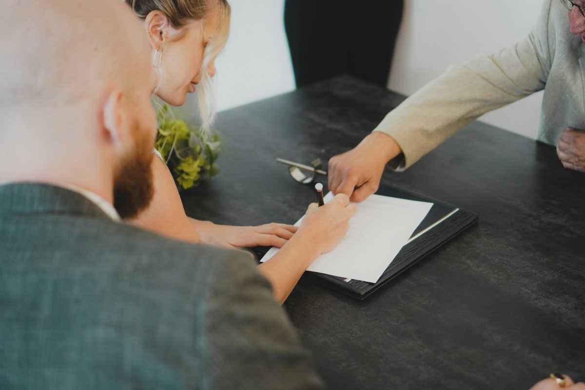 woman signing a paper - How Much Does a Hemp Permit License Cost in South Africa