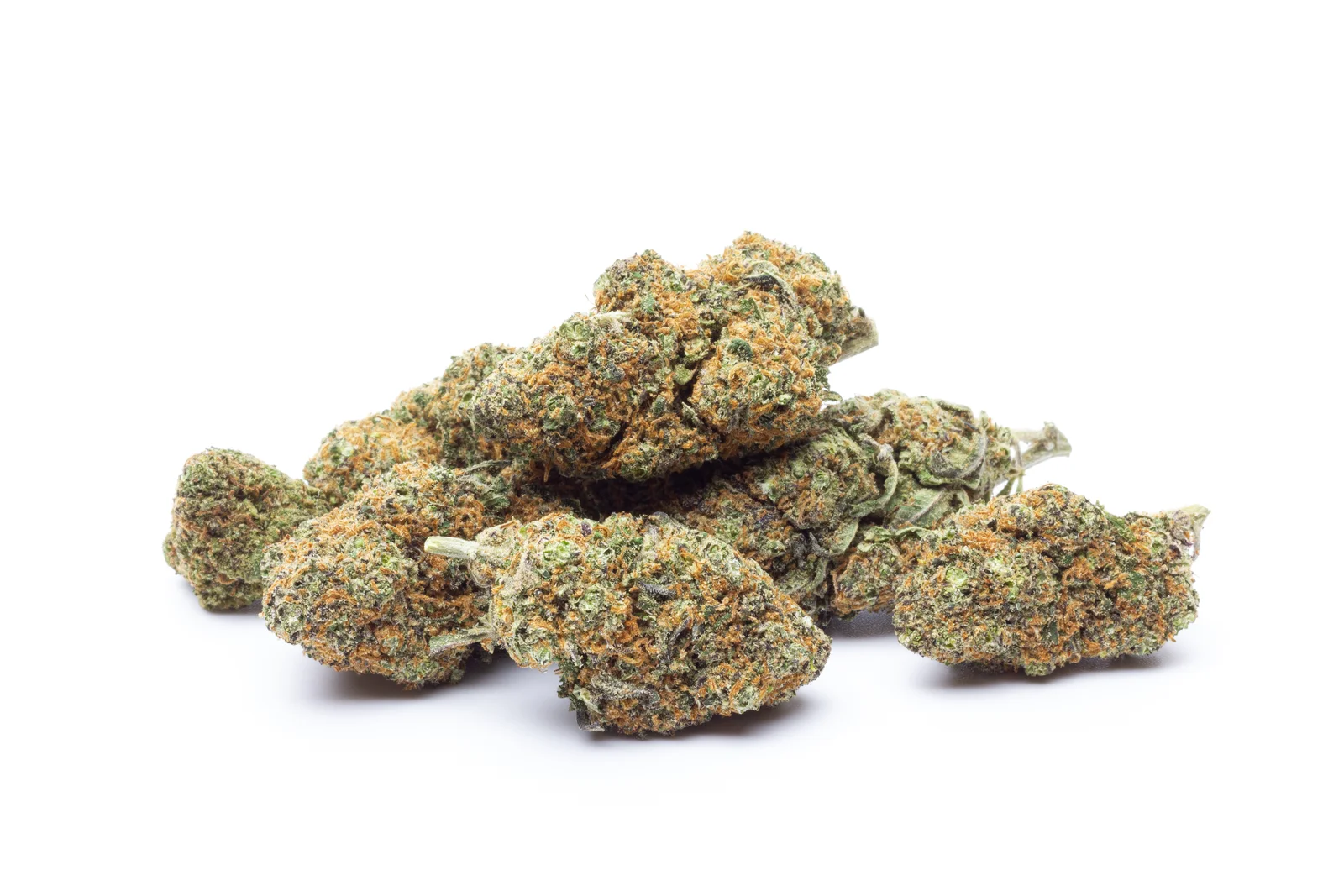 A clean, white background emphasizes the rich color and dense structure of dried cannabis buds. These are likely harvested from Cannabis indica strains, known for their compact, resin-heavy flowers often used for therapeutic or recreational purposes.