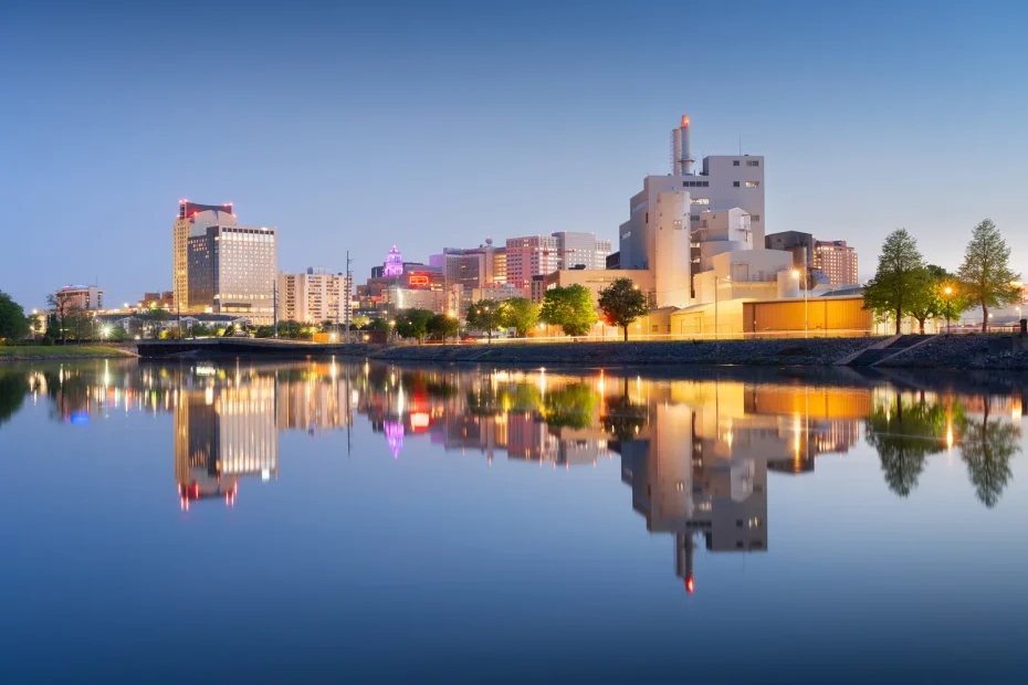Rochester city skyline reflected on the Zumbro River, representing business opportunities and local support from Minnesota Cannabis Consultants.