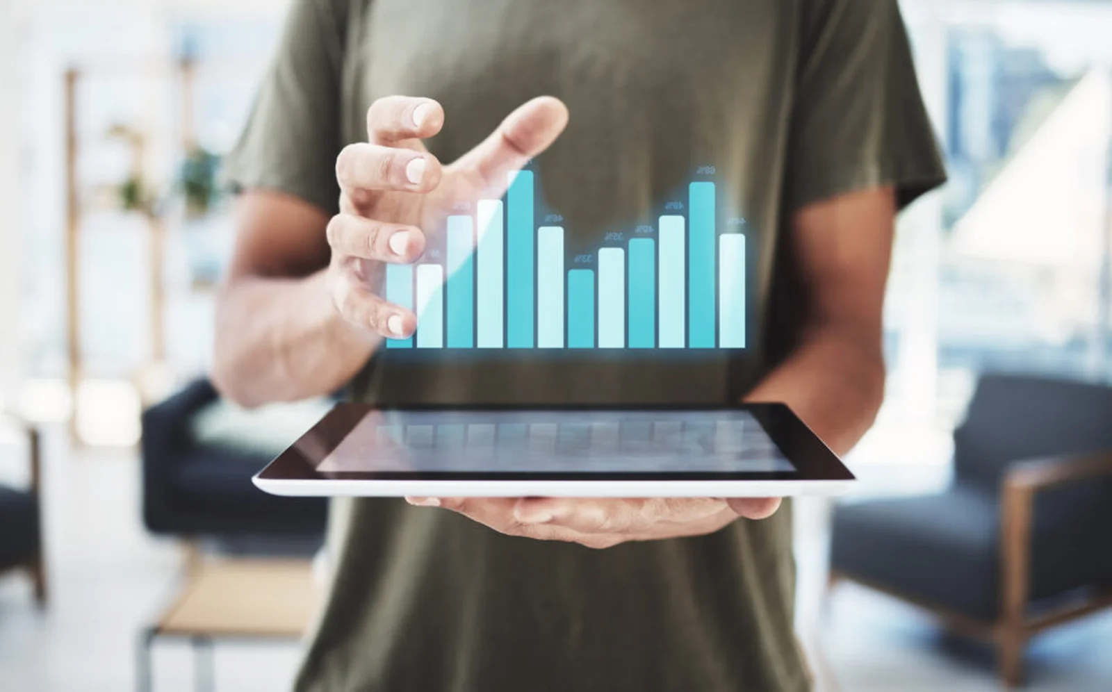 A person holds a tablet with a holographic bar chart, suggesting digital tools and analytics often used to track growth cycles and answer questions like “How Long Does It Take a Cannabis Plant to Grow?”
