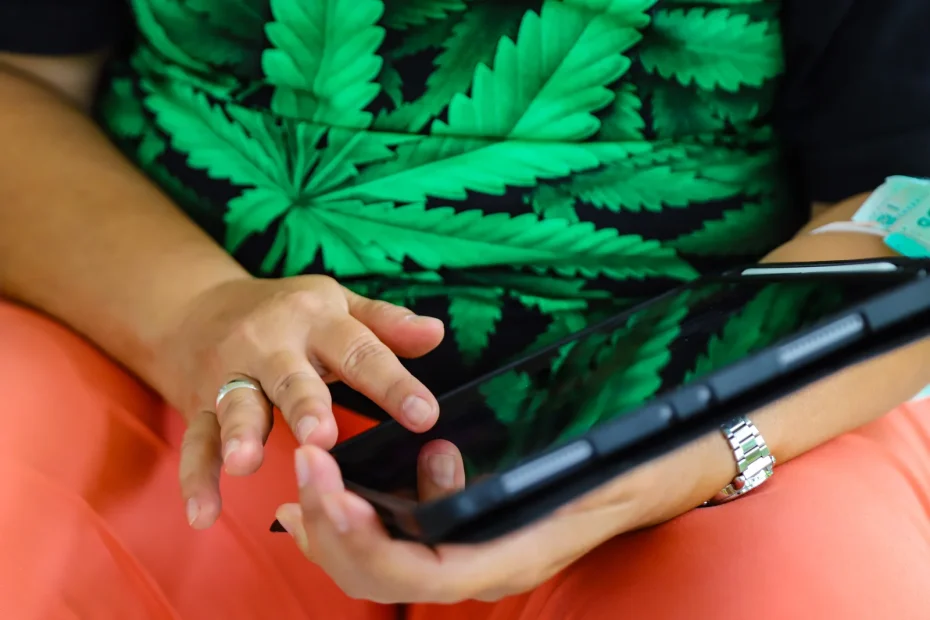 Close-up of hands using a tablet, symbolizing digital solutions and data management in cannabis operations — benefits of ERP for growers.
